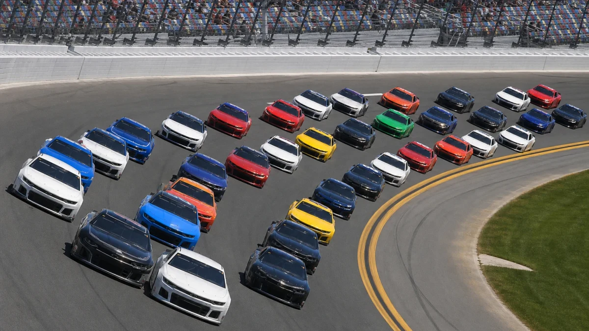 Stockcar-bilar i tät klunga på den doserade superspeedwayn i Daytona